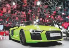  ??  ?? FRANKFURT: Two men take a closer look at a Audi R8 V10 plus on the second media day of the IAA Motor Show in Frankfurt yesterday.