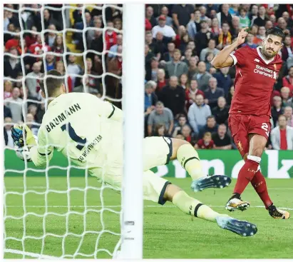  ??  ?? Liverpool’s German midfielder Emre Can scores Liverpool’s third goal during the Champions League qualifier second leg match between Liverpool and Hoffenheim on Wednesday night. (AFP)