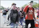  ?? Lynne Sladky ?? The Associated Press Students walk out of Marjory Stoneman Douglas High School as part of a nationwide protest against gun violence Wednesday in Parkland, Fla.