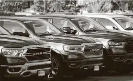  ?? David Zalubowski / Associated Press ?? 2020 pickups sit at a Ram dealership in Littleton, Colo. A report says the drop in mileage and increase in pollution were the first in five years.
