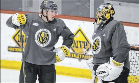  ?? L.E. Baskow Las Vegas Review-Journal @Left_Eye_ Images ?? Knights defenseman Nate Schmidt talks with veteran goaltender Marc-Andre Fleury during Friday’s practice at City National Arena.
