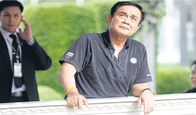  ?? THANARAK KHUNTON ?? Prime Minister Prayut Chan-o-cha takes a rest after his exercise session at Government House. Three years after the coup, his government appears embattled.