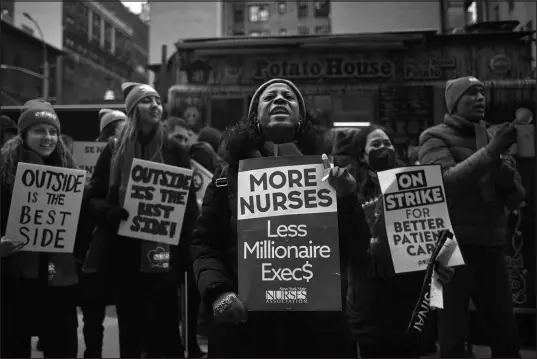  ?? ANDRES KUDACKI / ASSOCIATED PRESS ?? Nurses shout slogans and hold signs during a nursing strike Jan. 10 outside Mount Sinai Hospital in New York.