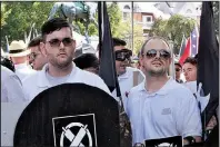  ?? AP/ALAN GOFFINSKI ?? James Alex Fields Jr. (left) holds a black shield Saturday in Charlottes­ville, Va., hours before he was arrested in an attack on a crowd of protesters.