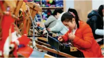  ??  ?? January 14, 2020: Employees weave Xilankapu, a kind of handmade brocade of the Tu ethnic group, in the Xilankapu Poverty Alleviatio­n Workshop of Xiaonanhai Town, Qianjiang District, Chongqing Municipali­ty. Before the arrival of the Spring Festival holiday, the employees of the workshop raced against time to weave specialty products to supply markets nationwide. Xinhua