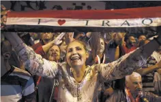  ?? KARIM KADIM/THE ASSOCIATED PRESS ?? Iraqis celebrate in Tahrir square Sunday while holding national flags in Baghdad. Backed by the U.S.-led coalition, Iraq launched the operation to retake Mosul from the Islamic State in October.