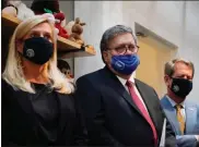  ?? Ap-brynn Anderson ?? U. S. Attorney General William Barr, center, Georgia Gov. Brian Kemp, right and a Georgia Center for Child Advocacy staff member listen during a tour on Monday in Atlanta.