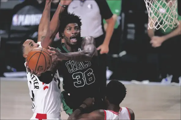  ?? ASSOCIATED PRESS ?? BOSTON CELTICS’ MARCUS SMART (36) GOES UP FOR a shot against Toronto Raptors’ Norman Powell (left) and Kyle Lowry during the second half of an NBA conference semifinal playoff game on Friday in Lake Buena Vista, Fla.