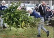  ?? TOM KELLY III — FOR DIGITAL FIRST MEDIA ?? Leo Wng watches as his twin brother Bill throws a Christmas Tree during the annual Christmas tree toss at the New Year’s Day celebratio­n at Pottstown’s Riverfront Park. The Wngs who are from China are visiting a cousin from Pottstown.