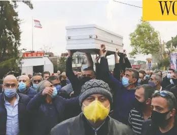  ?? ISSAM ABDALLAH / REUTERS ?? Mourners carry the coffin of Joe Bejjany, a 36-year-old telecoms employee and freelance photograph­er, at his funeral Tuesday in the village of Kahaleh, Lebanon, after he was killed assassin-style by two men with a silencer.