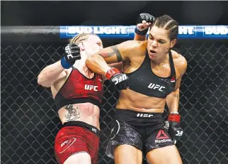  ??  ?? AMANDA NUNES (R) fights Valentina Shevchenko during UFC 215 at Rogers Place on Sept. 9 in Edmonton, Canada.
