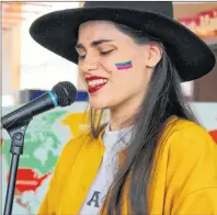  ?? GRACE GORMLEY/THE GUARDIAN ?? Anna Blanco showcases her voice and culture by performing traditiona­l Venezuelan music at the Diversity Fair Wednesday.