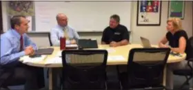  ?? SUBMITTED PHOTO ?? Sgt. Michael Vaughan, second from right, discusses security issues with high school Principal Joseph Hepp, Assistant Principal Anthony Simek, and school board member Melissa Butler.