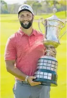  ?? Photo / AP ?? Jon Rahm with the championsh­ip trophy.