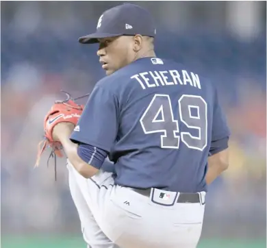  ?? (Photo by Manuel Balce Ceneta, AP) ?? Atlanta Braves starting pitcher Julio Teheran winds up during the first inning of Tuesday's game against the Washington Nationals.