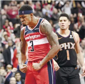  ?? AP FOTO ?? STOP THIS. Washington Wizards guard Bradley Beal celebrates after making two of his 40 points against the Suns.