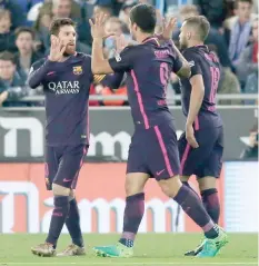  ?? — AFP ?? Barcelona’s Luis Suarez (centre) celebrates with Lionel Messi (left) after scoring during the Spanish league match against Espanyol at the Cornella-El Prat stadium in Cornella de Llobregat on Saturday.