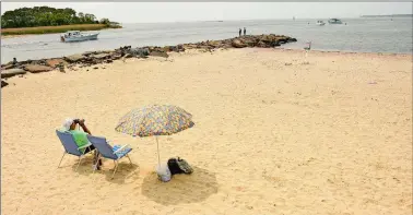  ?? TIM COOK/THE DAY ?? Beachgoers gather to enjoy a sunny Saturday morning June 1 at Niantic Bay Beach in Niantic.