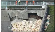  ?? AP/YUI MOK ?? A bag of aggregate — a mixture of sand, gravel and stone — is thrown Saturday onto the damaged Toddbrook Reservoir near the village of Whaley Bridge in Derbyshire, England.