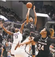  ?? Jessica Hill / Associated Press ?? South Carolina’s Mikiah Herbert Harrigan (21) makes a basket as UConn’s Christyn Williams (13) defends during the first half of Monday’s game in Hartford.