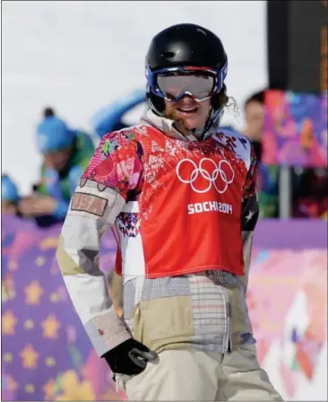  ??  ?? Lindsey Jacobellis of the United States reacts after crashing in the second semifinal of the women’s snowboard cross at the Rosa Khutor Extreme Park, at the 2014 Winter Olympics on Feb. 16 in Krasnaya Polyana, Russia.