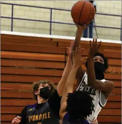  ?? DREW ELLIS — THE OAKLAND PRESS ?? Pontiac’s Octave Lawrence takes a shot over the defense of Avondale’s Brandon Minor (1) and Marshall Dennis (25) during Thursday’s game. Lawrence scored 15points to lead the Phoenix to a 51-44victory.