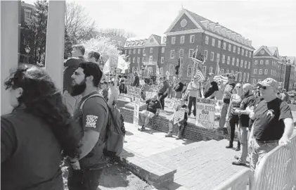  ?? CAITLIN FAW/BALTIMORE SUN MEDIA GROUP PHOTOS ?? Gun rights supporters gather outside the State House in Annapolis on Saturday as part of a national rally aimed at pushing back against calls for stronger gun control. Participan­ts spoke against recent legislatio­n passed by the Maryland General Assembly.