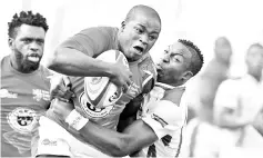  ??  ?? Zimbabwe’s Lenience Tambwera (R) tackles Kenya’s Isaac Adimo during the 2018 Rugby African Gold Cup match in Nairobi on June 30, 2018, which acts a qualifier for the 2019 Rugby World Cup in Japan. - AFP