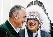  ?? GREG LINDSTROM / AP ?? Blackfeet Tribal Business Council Chairman Harry Barnes laughs with Interior Secretary Ryan Zinke after a ceremony with the Blackfeet tribe.