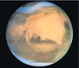  ?? REUTERS/NASA ?? Martian beauty . . . Frosty white water ice clouds and swirling orange dust storms above a vivid rusty landscape reveal Mars as a dynamic planet in this sharpest view ever obtained by an Earthbased telescope. Nasa’s Earthorbit­ing Hubble Space Telescope took the picture on June 26, 2001 when Mars was about 68 million km from Earth.