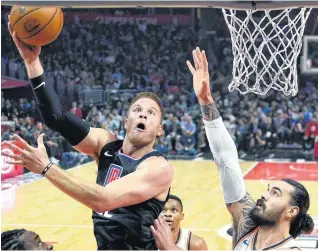  ?? [AP PHOTO] ?? Los Angeles Clippers forward Blake Griffin, left, shoots as Oklahoma City Thunder center Steven Adams defends during the first half of Thursday night’s game in Los Angeles. The Thunder won, 127-117.