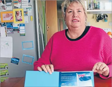  ?? Photo: ABBY BROWN ?? STOKED SUPPORTER: Silver Fern Casey Kopua’s mum Joanne Williams with her tickets to the Commonweal­th Games pool and final netball games.