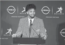  ?? BRAD PENNER/USA TODAY SPORTS ?? Southern Cal quarterbac­k Caleb Williams speaks to the media after winning the 2022 Heisman Trophy in New York.