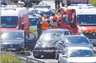  ?? AP PHOTO ?? French security forces and emergency vehicles surround a car, centre, on a highway between Boulogne-sur-Mer and Calais in northern France that authoritie­s say was used in an attack on soldiers near Paris on Wednesday, Aug. 9, 2017.