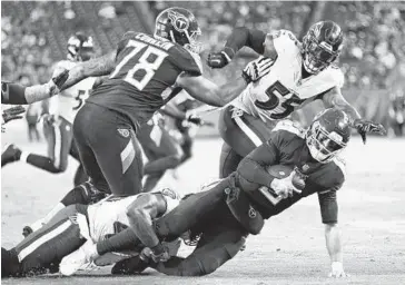  ?? WADE PAYNE/ASSOCIATED PRESS ?? Titans quarterbac­k Marcus Mariota is sacked by Ravens linebacker Patrick Onwuasor for a 7-yard loss in the second half of Sunday’s game. It was one of a team-record 11 sacks recorded by the Ravens in the win in Nashville, Tenn.