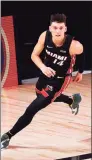  ?? Kevin C. Cox / TNS ?? Tyler Herro of the Miami Heat reacts after a layup during the fourth quarter against the Boston Celtics on Wednesday in Lake Buena Vista, Fla.