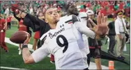  ?? Darron Cummings / Associated Press ?? Cincinnati quarterbac­k Desmond Ridder throws a football into the stands on Saturday in South Bend, Ind.