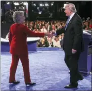  ?? FILE PHOTO ?? Hillary Clinton and President Donald J. Trump shake hands.