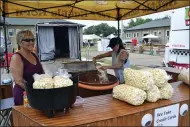  ??  ?? Geri Ferguson, left, of longtime Lake County Fair vendor Pap’s Kettle Corn, said it was great to be back and enjoying the energy of the fair after a year away.