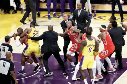  ?? — AP ?? Houston Rockets’ Chris Paul ( far left) is held back by Los Angeles Lakers’ LeBron James after Paul fought with Lakers’ Rajon Rondo ( far right) during the second half of an NBA basketball game in Los Angeles on Saturday. The Rockets won 124- 115.