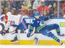  ?? DEREK CAIN/GETTY IMAGES ?? The Canucks' Elias Pettersson is checked by the Habs' Brendan Gallagher during Thursday's game at Rogers Arena.