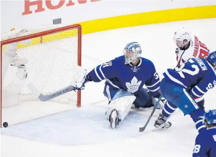  ?? PETER J. THOMPSON ?? Washington Capitals forward Marcus Johansson scores past Toronto Maple Leafs goalie Frederick Andersen in overtime in Game 6 on Sunday in Toronto. The Capitals won the game 2-1 and will advance to play the Pittsburgh Penguins in the second round.