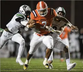 ?? DANIEL VARNADO FOR THE AJC ?? North Cobb quarterbac­k Malachi Singleton (3), who is trying to break tackles against Roswell on Nov. 19, earned a spot on the All-AJC Class 7A team.
