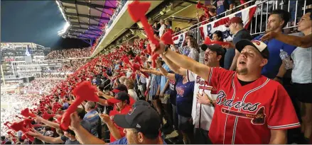  ?? JASON GETZ FOR THE AJC 2018 ?? Braves fans participat­e in the tomahawk chop before a game in 2018. The tomahawk chop has been a part of Braves home games since 1991, spreading to the team’s fans from Florida State when FSU alum Deion Sanders played for the Braves.