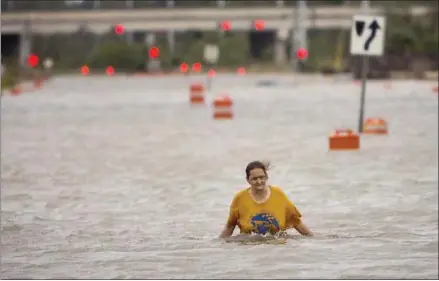  ?? STEPHEN B. MORTON — THE ASSOCIATED PRESS ?? A homeless woman who identified herself as Valerie works her way along flooded President Street in Savannah, Ga., after leaving her homeless camp when Hurricane Matthew caused flooding Saturday. The woman said her camp was washed away and she had to...