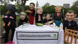  ?? — AFP ?? Members of Oxfam dressed as the ‘ G7 leaders’ pose for pictures outside the Quebec provincial building ahead of the G7 summit in Quebec City, Quebec, Canada, on Thursday.