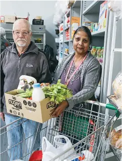  ??  ?? Volunteer at the Food Relief shop in Warragul Delilah Lott with Cameron Jack arrange a package of groceries.