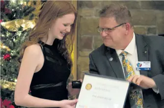  ?? JASON BAIN/ EXAMINER ?? Cuddles for Cancer founder Faith Dickinson accepts a Paul Harris Fellow Award for Vocational Service from Rotary district governor Mike Kinsey during a presentati­on that followed a gala dinner at Peterborou­gh Golf and Country Club on Monday night. See...