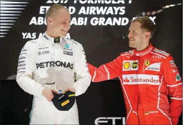  ?? Picture: EPA-EFE ?? I KNOW THAT SMILE ALL TOO WELL: Sebastian Vettel congratula­tes Valtteri Bottas after the Mercedes driver won in Abu Dhabi yesterday