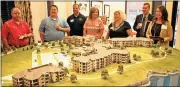  ?? File, Spencer Lahr / Rome News-Tribune ?? Berry is negotiatin­g a payment in lieu of taxes plan with the city for The Spires, the retirement community that it showcased with this model during the July Downtown Coffee Break.